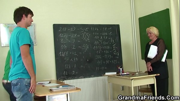 Old blonde teacher swallows two young cocks at once